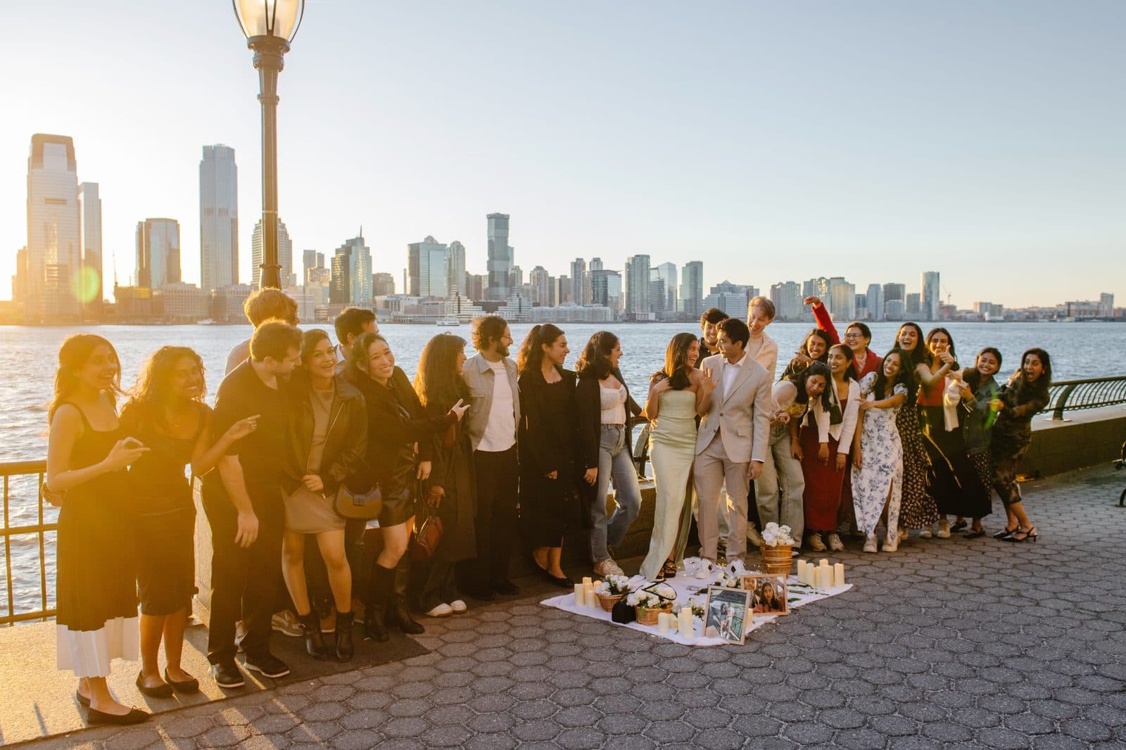 Krati and Shaan celebrating their engagement with friends at sunset