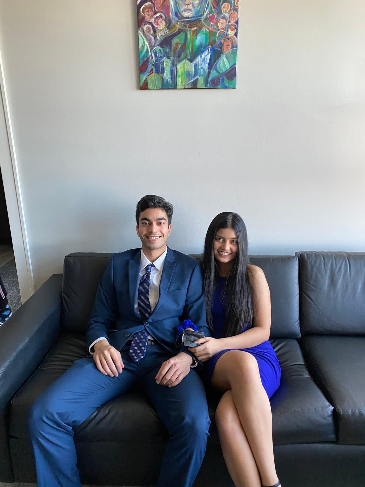 Krati and Shaan dressed up and seated together on a sofa