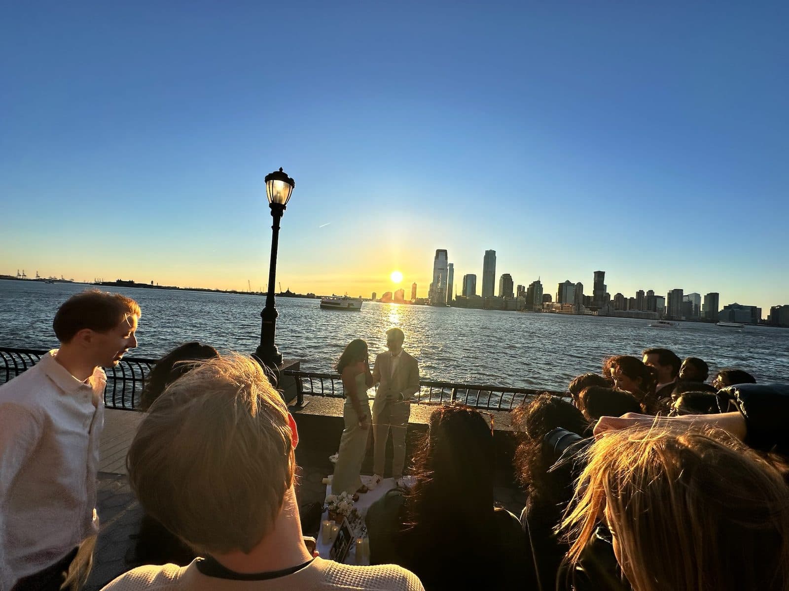 Friends surrounding Krati and Shaan at the waterfront proposal